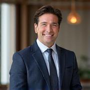 Portrait of a sophisticated male account manager in a suit, smiling confidently